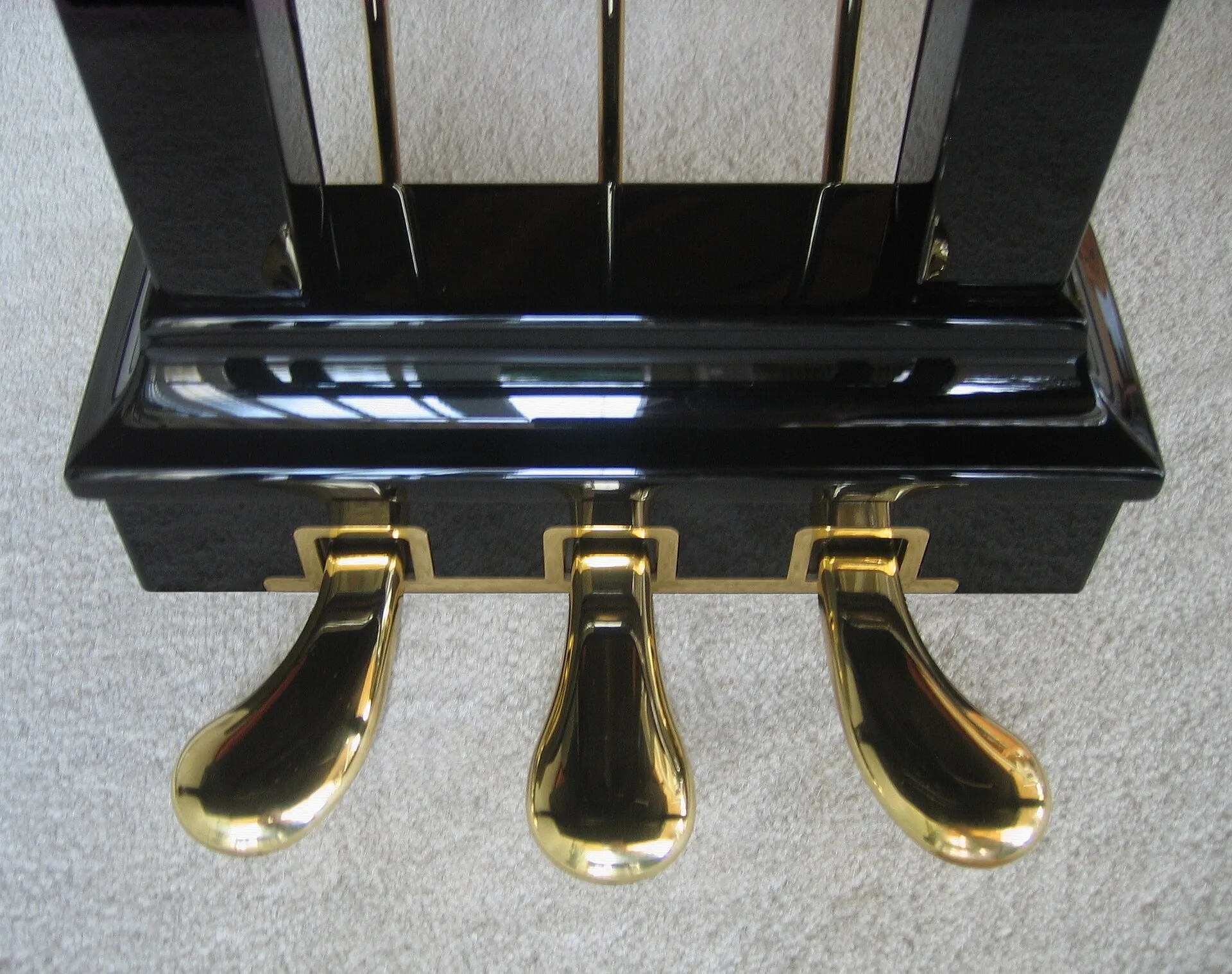 Gold pedals of a grand piano